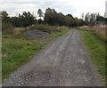 Pile of gravel alongside an access road near Grovesend