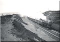 An 8F heads south over Shap Summit with a fast freight