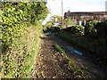 Farm track and barn near Pant Glas