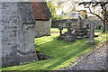 West angle buttress and damaged cross at All Saints Church