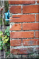 Benchmark on house beside A329 near Upper Grange