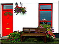 M2208 : Ballyvaghan B&B - White Wall, Red Door & Window, Bench & Flowers by Joseph Mischyshyn