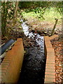 Brick-lined stream channel near Pentwynmawr