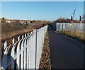 Grey fences alongside Concorde Way, Filton