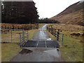 NN3391 : Cattle grid on road to Brae Roy Lodge by Steven Brown