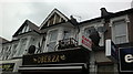 View of a cart and two barrels above Oberza cafe on High Road, Ilford