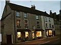 Dusk falls on shops at the bottom of Long Street Tetbury