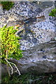 Benchmark on rock at base of wall of St Michael