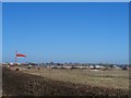 Cranfield Airport with windsock and newly cut hedge