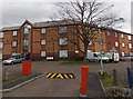 Yellow and black barrier at the entrance to Tŷ Tudur flats, Cwmbran