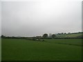 View south across farmland to a cottage on the New Road