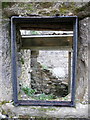 Iron window frame in ruined cottage at Old House