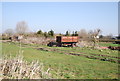 TQ8745 : Rusting farm machinery by N Chadwick
