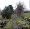 Path through the churchyard of a disused church in Blakeney