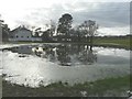 Large pool of floodwater beside The Mead