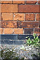 Benchmark on brick wall on north side of Soar Lane