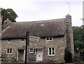 Cottage and signpost at Forder Bridge