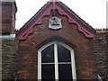 Date and crest on building in Market Hill, Orford