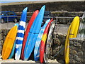 SW4626 : Canoes against harbour wall, Mousehole by David Hawgood