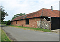 Brandiston Road past barn conversion by Church Farm