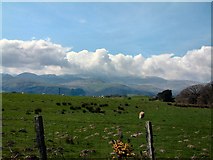 SH8257 : View towards Snowdonia from the B5113 by Gerald England