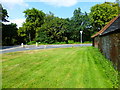 Approaching Ash Road along the verge by Aldershot Road