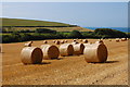SY9179 : Field with straw bales by Trevor Harris