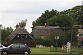 View of thatched cottages in Matching Green from the green