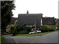 SP5859 : Thatched cottage and war memorial, Newnham by Bikeboy
