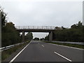 TM2986 : A143 Old Railway Road & Bridge by Geographer
