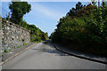 Minor road leading to a footbridge over the A55