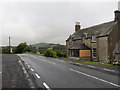 NY4783 : Road (B6357) and Empty House at Under Burnmouth by Peter Wood