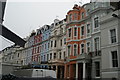 View of coloured houses on Colville Terrace from Portobello Road