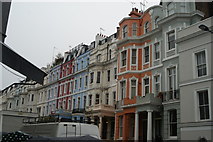 TQ2481 : View of coloured houses on Colville Terrace from Portobello Road by Robert Lamb