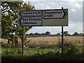 TM0760 : Roadsigns on the A1120 Church Road by Geographer