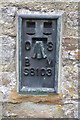 Benchmark on building on north side of A684 in Worton