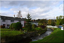 NY3239 : Colourful houses next to Gill Beck, Caldbeck by Tim Heaton