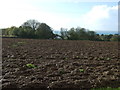 SX0952 : Ploughed field towards Penillick by JThomas