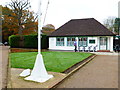 Pro shop on golf course with flagpole in foreground