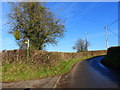 The road at the junction with a footpath to Kincoed