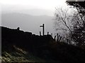 Silhouetted stile and fingerpost