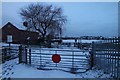 Railway crossing at dawn with snow