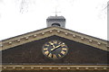 View of the clock on the front of the Geffrye Museum from the front garden