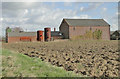 Two old boilers beside farm buildings at Tannington