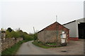 Barns and fuel pump by the road through Atterby
