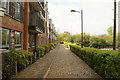 View down a cobbled path next to the flats on Mill Road