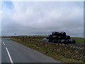 SK0453 : Bags of silage at roadside by Bikeboy
