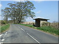 NZ1271 : Bus stop and shelter on the road towards Stamfordham by JThomas