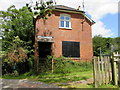 Boarded-up house alongside a Yetminster railway level crossing