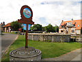 Upper Sheringham village sign and the spring reservoir